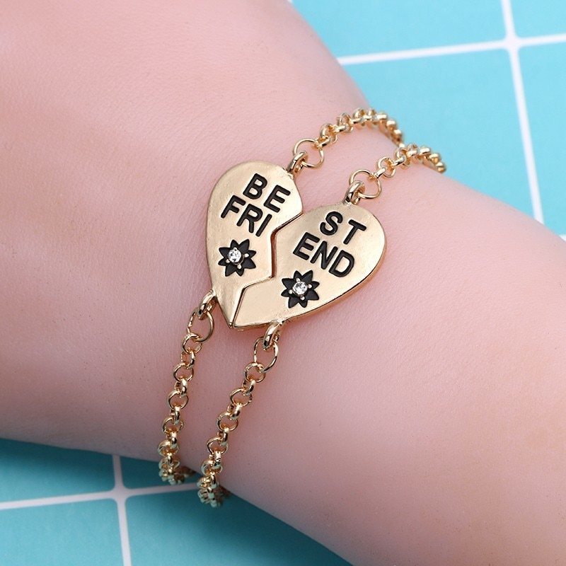 Heart-shaped best friends bracelet in gold, featuring English letters and inlaid gems.