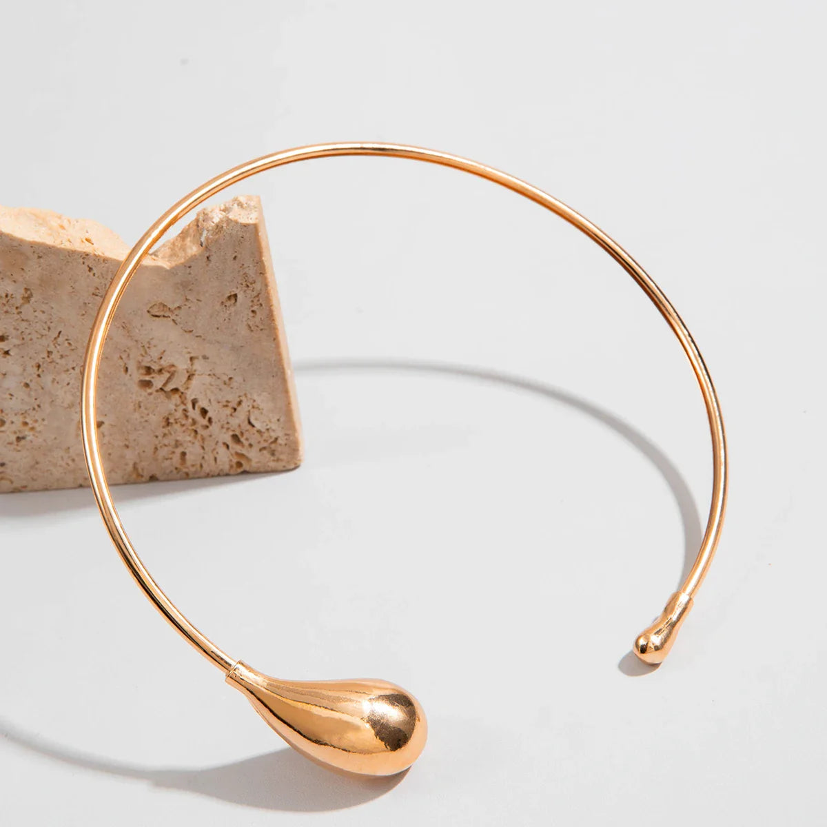 Gold geometric torque choker necklace for women made of zinc alloy metal.