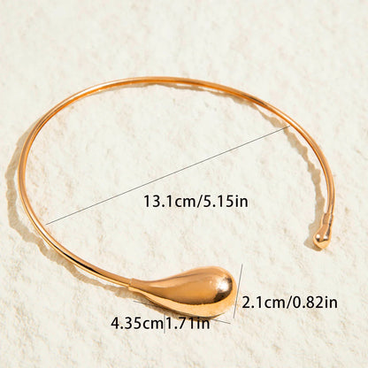 Gold geometric zinc alloy choker necklace for women with teardrop detail and size measurements on textured background